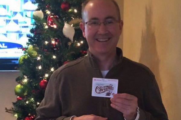 Man holding christmas gift card