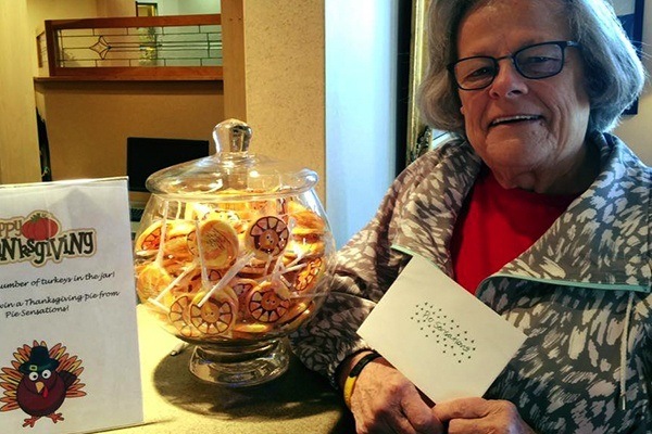 Woman posing next to vase filled with cookies