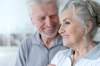 Older woman with All-on-4 in Columbia smiling with her husband