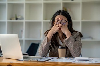 Exhausted woman sitting at desk