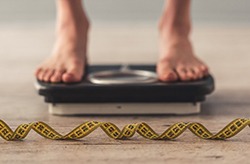 Person’s feet on bathroom scale