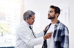 Doctor listening to patient’s heart