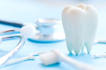 Tooth and dental tools on tray