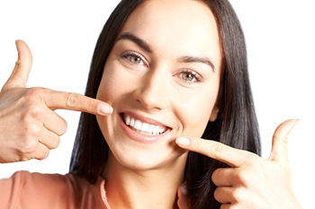 Woman pointing to her healthy teeth