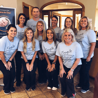 Group of dental team members wearing blue matching shirts