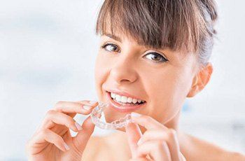 Woman placing ClearCorrect tray