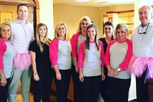 Team members dressed in pink