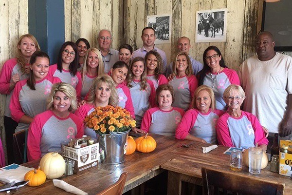 Team dressed in pink baseball t-shirts