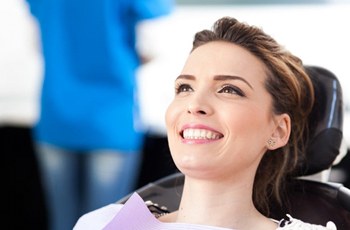 Woman smiling in dental chair after dental bonding