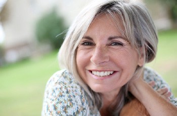 a woman smiling with dentures in Columbia