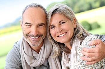 Older couple with with dentures smiling