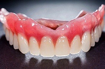 Closeup of temporary dentures in Columbia on dark background