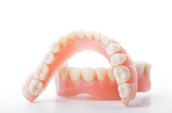 Closeup of full dentures in Columbia on white background