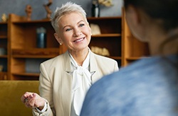 a person practicing speaking with their new dentures