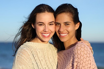Two female friends with beautiful smiles