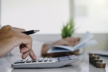 Man calculating cost of dental emergency in Columbia