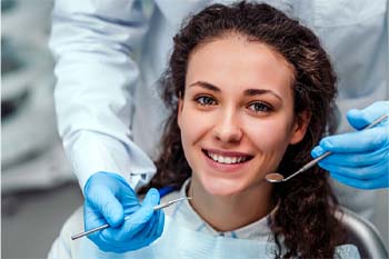 Woman smiling while visiting her emergency dentist in Columbia