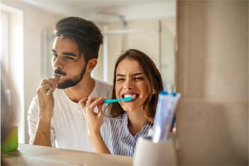 Couple brushing their teeth together