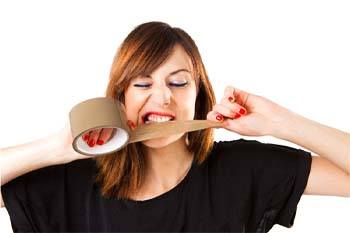 Woman biting into roll of duct tape to cut it