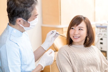 woman talking to her dentist about salvaging her dental implants in Columbia, TN