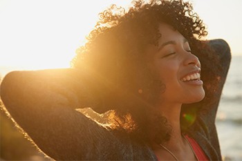 woman with tooth colored fillings smiling into the sunset