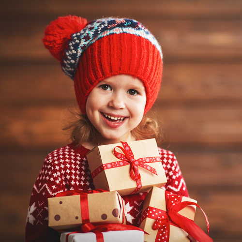 Child holding gift wrapped packages