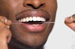 closeup of a man flossing