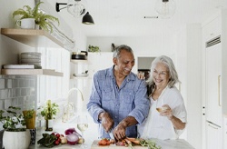 elderly couple cooking together