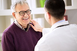 dentist and patient discussing how to make dental implants affordable in Columbia