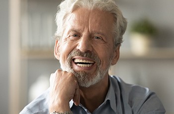 Image of a lower denture being attached to dental implants