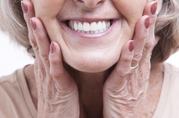 Image of a lower denture being attached to dental implants