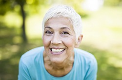 woman with dental implants in Columbia grinning from ear to ear 