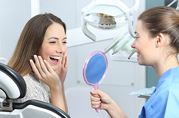 Young woman admiring her new dental implants in Columbia