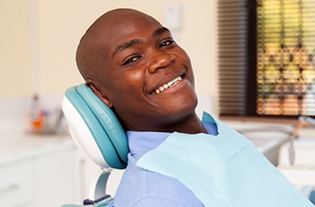 Man smiles while visiting Columbia implant dentist