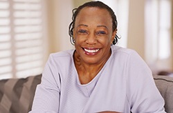 Smiling woman with dental implants in Columbia
