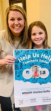 Dental team member and child at community event