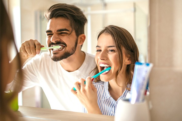 couple brushing teeth