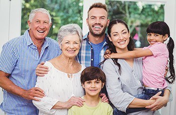 Three generations of smiling family after preventive dentistry visit