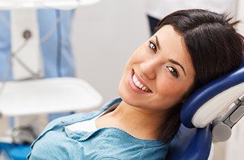 Woman smiling during dental checkup and teeth cleaning visit