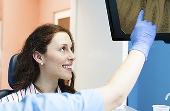 Woman and dentist looking at digital x-rays