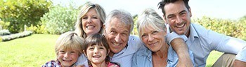 Three generations of family smiling after preventive dentistry visit