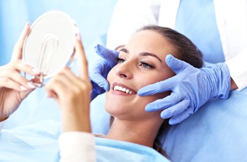 woman admiring her new smile