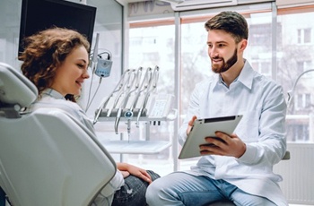 dentist showing a tablet to a patient