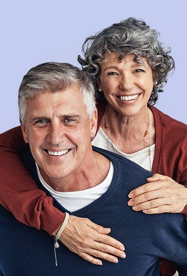 Older couple with healthy smiles after restorative dentistry