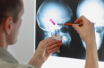 Dentist in Columbia examining an X-ray