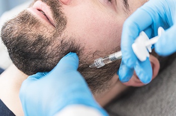Dentist in Columbia administering BOTOX® for TMJ symptoms
