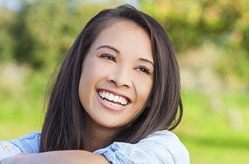 Woman with flawless smile after porcelain veneers