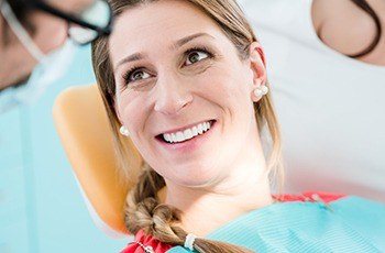 Woman smiling during porcelin veneer treatment