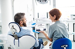dentist discussing X-ray with patient