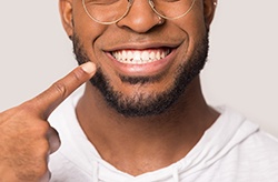 man pointing to white smile 